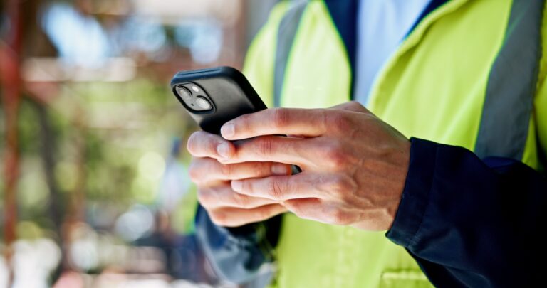 Field worker entering data on mobile phone