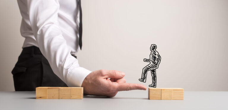 Man using his hand as a bridge across wooden blocks